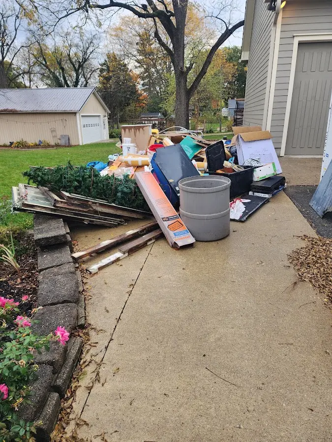 Dumpster being loaded with debris for Estate Cleanout Dumpster Rental in Emporia